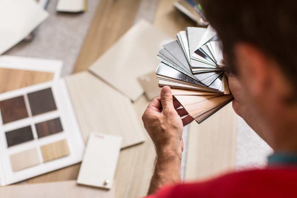 comparing laminate and vinyl floor samples for new project